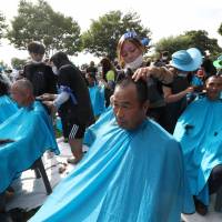 Residents of Seongju, South Korea, get their heads shaved during a protest Monday against the government\'s decision to place a U.S. Terminal High Altitude Area Defence (THAAD) anti-missile defense unit in their town. | REUTERS
