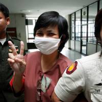 Daranee Charnchoengsilpakul, a supporter of ousted premier Thaksin Shinawatra, gestures after leaving a courtroom in Bangkok in this August 2009 file photo. | REUTERS