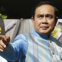 Thai Prime Minister Prayuth Chan-ocha points as he arrives for a cabinet meeting in Bangkok on Tuesday. | AP
