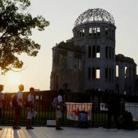 People view the Atomic Bomb Dome in the city of Hiroshima in August last year. | KYODO