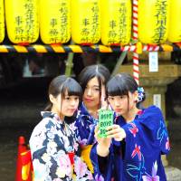 Women in yukata casual kimono take a selfie with their smartphone at the Mitama Matsuri festival at Yasukuni Shrine in Tokyo\'s Chiyoda Ward on July 16. | YOSHIAKI MIUIRA