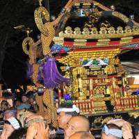 Men carry a mikoshi portable shrine as they parade during the Mitama Matsuri at Yasukuni Shrine in Chiyoda Ward, Tokyo, on July 16. | YOSHIAKI MIURA