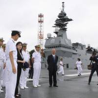 Defense Minister Tomomi Inada (third from left) inspects the helicopter carrier Izumo in Yokosuka, Kanagawa Prefecture, on Tuesday. | KYODO