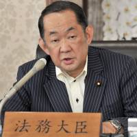 Justice Minister Katsutoshi Kaneda addresses reporters at the ministry on Tuesday. | YOSHIAKI MIURA