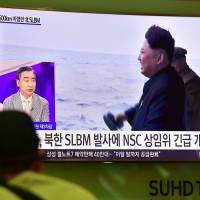 A man watches television news showing file footage of North Korea\'s leader Kim Jong Un during a missile launch at Incheon airport, west of Seoul, on Wednesday. | AFP-JIJI