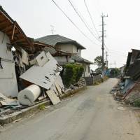 Damaged homes remain untouched Sunday in the town of Mashiki four months after a killer earthquake hit Kumamoto Prefecture. | KYODO