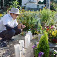 Shinizo Tatsukawa, 79, who lost his elder brother Yoji in a massive landslide that killed 77 people in Hiroshima\'s Asaminami Ward in 2014, prays for the victims Saturday on the second anniversary of the disaster. | KYODO