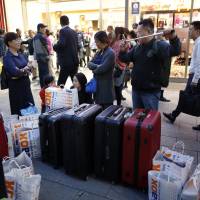 Tourists won\'t have to carry their suitcases while traveling in Japan anymore under an upcoming service that requires their precise itinerary details be submitted for conversion into barcodes in advance. | BLOOMBERG
