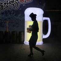 A waitress carries mugs of beer during the Taedonggang Beer Festival in Pyongyang on Aug. 21. The festival, the first of its kind in North Korea, was held as a promotional event for domestic beer. | AP