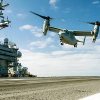 A MV-22B Osprey lands on the aircraft carrier USS Carl Vinson on June 12 in the Pacific Ocean. | U.S. NAVY / VIA KYODO
