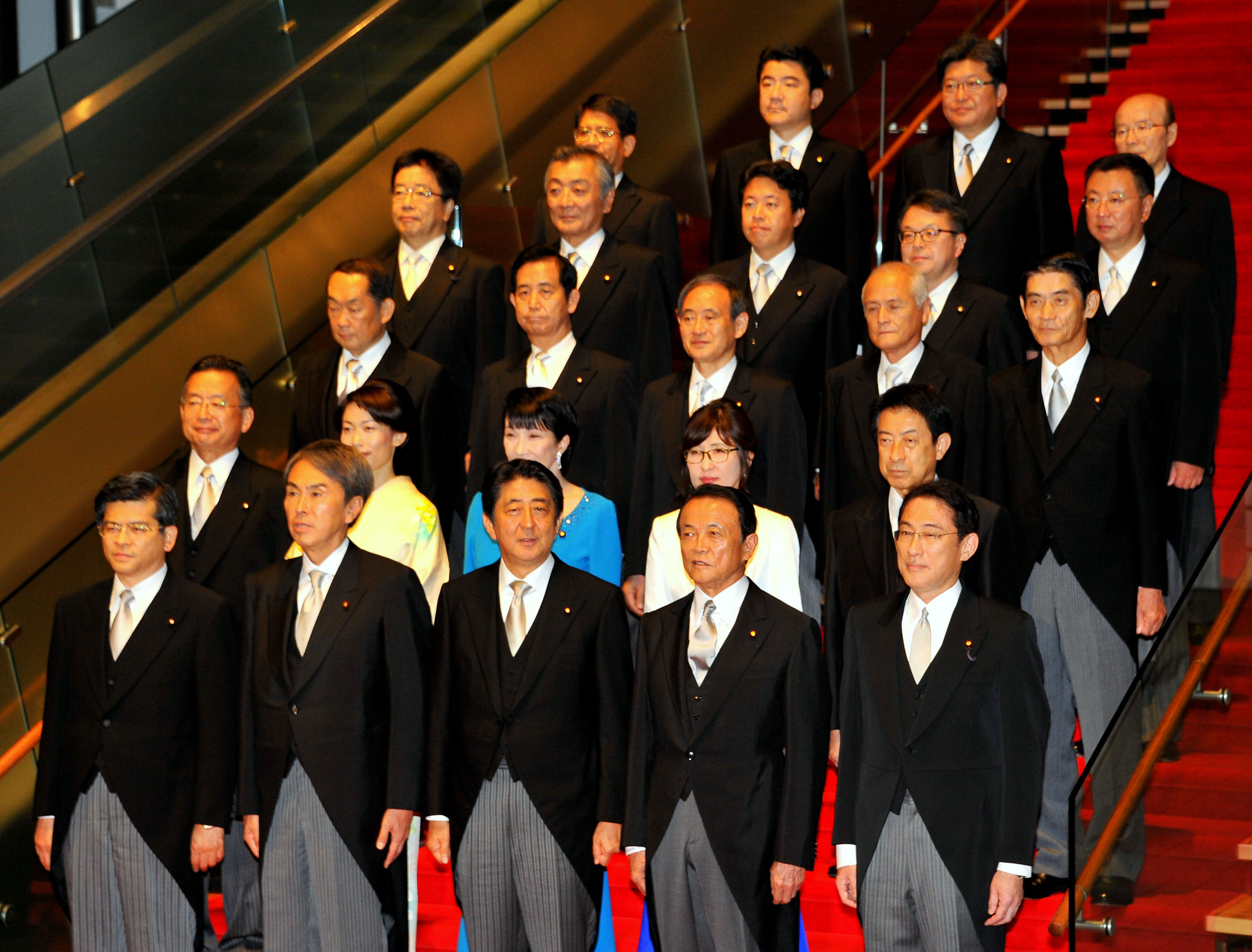 Prime Minister Shinzo Abe and members of his new Cabinet gather for a photo Wednesday evening at the Prime Minister's Office. | YOSHIAKI MIURA