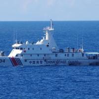 A China Coast Guard vessel is seen in waters near the Japanese-controlled Senkaku Islands on Saturday morning. | JAPAN COAST GUARD / VIA KYODO