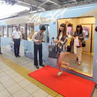 Passengers exit Seibu Railway Co.\'s restaurant train, 52 Seats of Happiness, after it arrives at Tokorozawa Station in Saitama Prefecture on July 27. | YOSHIAKI MIURA