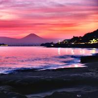 Summer breeze: Mount Fuji is seen from a beach in Kanagawa Prefecture at sunset. Hitting Japan's best beaches