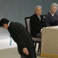 Symbols of state: Prime Minister Shinzo Abe bows before the main altar as Emperor Akihito and Empress Michiko watch during a memorial service at Nippon Budokan Hall in Tokyo on Aug. 15, the 71st anniversary of Japan’s surrender at the end of World War II . | AP