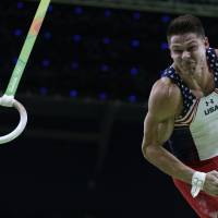 United States\' Chris Brooks performs on the rings during the artistic gymnastics men\'s qualification at the 2016 Rio de Janeiro Olympics on  Saturday. | AP