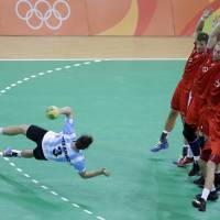 Argentina\'s Federico Pizarro tries to score during the men\'s preliminary handball match between Denmark and Argentina at the 2016 Summer Olympics in Rio de Janeiro on Sunday. | AP