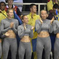 Supporters of Sweden\'s Sarah Sjostrom have her name written on their bellies during the women\'s 100-meter butterfly final on Sunday at the 2016 Summer Olympics in Rio de Janeiro. | AP