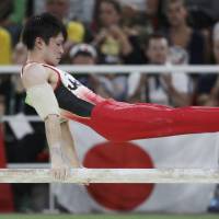 Kohei Uchimura competes on the parallel bars during the men\'s gymnastics team final en route to winning the gold medal on Monday at the 2016 Rio de Janeiro Olympics. | REUTERS