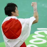 Kohei Uchimura celebrates after winning the gold medal in the men\'s individual all-around final on Wednesday at the 2016 Rio de Janeiro Olympics. | REUTER