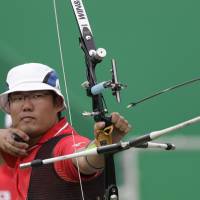 Takaharu Furukawa releases his arrow during an elimination round of the individual archery competition at the 2016 Summer Olympics in Rio de Janeiro on Wednesday. | AP