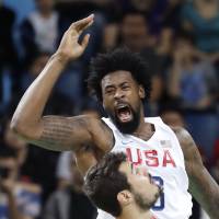 United States\' DeAndre Jordan reacts as he scores over Serbia\'s Nikola Kalinic during a men\'s basketball game at the 2016 Summer Olympics in Rio de Janeiro on Friday. | AP