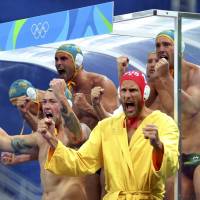 The Australian team cheers from the benches during a preliminary round of the men\'s water polo at the Maria Lenk Aquatics Center at the Rio de Janeiro Olympics on Friday. | AP