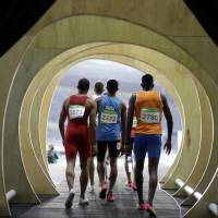 Athletes enter the stadium to compete in a men\'s 400-meter heat during the track and field competitions at the Olympic stadium in Rio de Janeiro on Friday. | AP