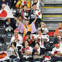 Japanese fans cheer from the stands at the badminton venue at the 2016 Rio de Janeiro Olympics on Friday. | KYODO