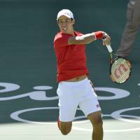 Kei Nishikori returns a shot during a 6-1, 6-4 loss to Andy Murray in the semifinals of the men\'s singles competition on Saturday at the 2016 Rio Olympics. | KYODO