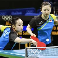Mima Ito (left), playing with doubles partner Ai Fukuhara, hits a shot during Japan\'s women\'s table tennis team quarterfinal match against Austria at the 2016 Rio Olympics on Saturday. | KYODO