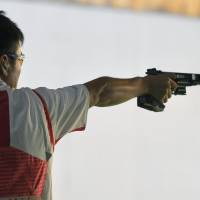 Eita Mori shoots during the men\'s 25-meter rapid fire pistol qualification round at the 2016 Summer Olympics in Rio de Janeiro. | KYODO