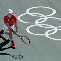 Kei Nishikori returns the ball to Spain\'s Rafael Nadal on Sunday during their match for the bronze medal in men\'s singles tennis at the 2016 Rio Olympics. Nishikoro won the match 6-2, 6-7 (1-7), 6-3. | KYODO