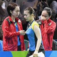 Ai Fukuhara (center) exits while teammates Kasumi Ishikawa  and Mima Ito react after losing their women\'s table tennis team semifinal match 3-2 to Germany at the 2016 Rio Olympics on Sunday. | KYODO