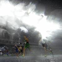 Heavy rain hits the men\'s 110-meter hurdles heat on Monday night at the 2016 Summer Olympics in Rio de Janeiro. | AP