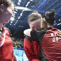 Ai Fukuhara (center) hugs Mima Ito (right) while Kasumi Ishikawa watches after winning the women\'s team bronze for the table tennis match against Singapore at the 2016 Rio de Janeiro Olympics on Tuesday. | KYODO