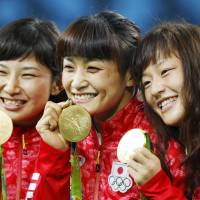 Gold medalists Sara Dosho (left), Kaori Icho (center) and Eri Tosaka pose after winning the women\'s wrestling finals on Wednesday at the 2016 Summer Olympic Games in Rio de Janeiro. | KYODO