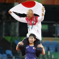 Sara Dosho celebrates with her coach Kazuhito Sakae on her shoulders after capturing the gold medal for the women\'s wrestling freestyle 69-kg category on Wednesday at the 2016 Rio de Janeiro Summer Olympics. | KYODO