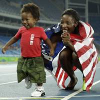 Nia Ali of the United States poses with her son, Titus, after earning the silver medal at the women\'s 100-meter hurdles event on Wednesday at the 2016 Rio de Janeiro Olympics. | AP