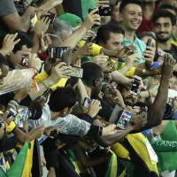Jamaica\'s Usain Bolt celebrates with spectators after winning the gold medal in the men\'s 200-meter final at the 2016 Summer Olympics on Thursday. | AP