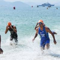 Hirokatsu Tayama of Japan completes the swimming portion of the men’s triathlon at the Rio de Janeiro Olympics on Thursday. He later withdrew from the competition. | KYODO