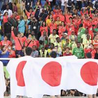 Japan\'s track team members celebrate the country\'s 4x100-meter relay team from the stands after they captured a silver medal in the men\'s competition at the Rio de Janeiro Olympics on Friday. | KYODO