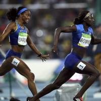 United States\' English Gardner hands the baton to anchor Tori Bowie during the women\'s 4x100-meter relay final at the Rio de Janairo Olympics on Friday. The team won the gold medal for the second straight Summer Games. | REUTERS