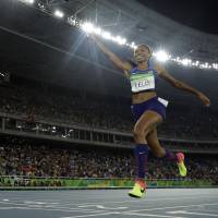 The United States\' Allyson Felix crosses the line to capture the gold medal in the women\'s 4x400-meter final on Saturday at the 2016 Rio Olympics. | AP