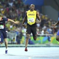 Usain Bolt of Jamaica (C) runs to win the gold in 200 meters at the 2016 Rio Olympics. | REUTERS