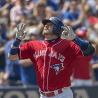 Toronto’s Josh Donaldson celebrates after hitting a home run in the third inning of the Blue Jays’ 9-6 win over the Twins on Sunday. Blue Jays' Donaldson hits three home runs
