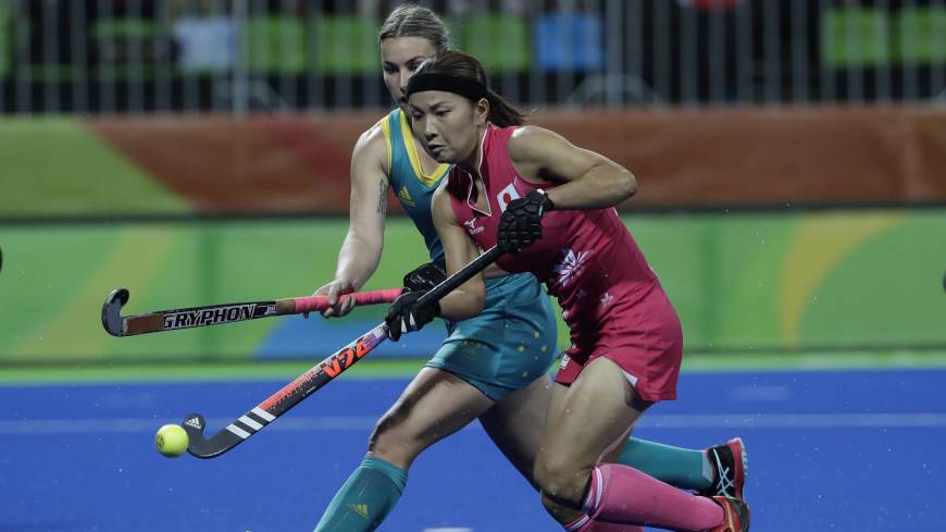 Japan’s Nagisa Hayashi (foreground) vies for the ball with Australia’s Mariah Williams during a women’s field hockey match at Rio Olympics on Saturday in Rio de Janeiro. Japan drops final match of Olympic tournament