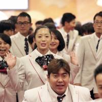Sprinter Saki Takakuwa (center) and other Japanese Paralympians leave a hotel ballroom in Tokyo during a send-off event on Tuesday for September\'s Rio de Janeiro Paralympic Games. | KAZ NAGATSUKA
