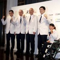 Wheelchair tennis player Yui Kamiji (far right), wheelchair basketball player Reo Fujimoto (second from right), Japanese Paralympic delegation leader Hiroya Otsuki (center) and other delegation executives pose for a photo after Tuesday\'s send-off events in Tokyo. | KAZ NAGATSUKA