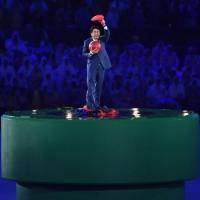 Prime Minister Shinzo Abe stands on a stage made to look like a pipe after entering the venue dressed as the video game character Mario at the 2016 Summer Olympics closing ceremony in Rio de Janeiro on Sunday. | KYODO